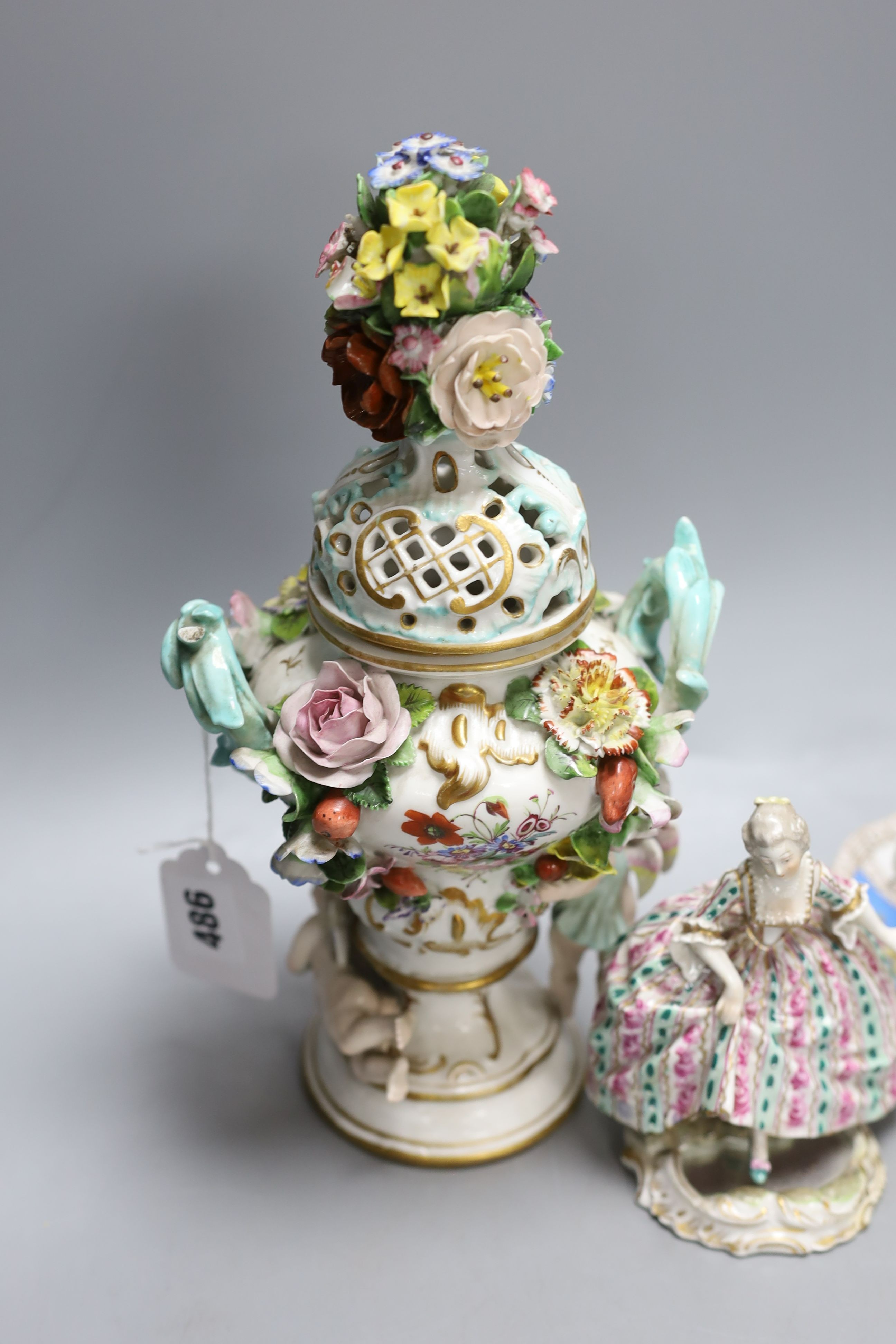 A Dresden floral encrusted pot pourri vase and cover, 29cm tall, a figure of a lady and a Dresden cup and trembleuse saucer